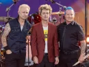 Mike Dirnt^ Billie Joe Armstrong^ Tre Cool pose on stage during ABC Good Morning America rock group Green Day concert in Central Park in New York on July 26^ 2024