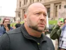 Alex Jones^ flanked by bodyguards^ leaves a rally protesting Covid-19 stay at home orders at the Capitol that was heavily promoted by his Infowars website. Austin^ Tx/USA - Apr. 18^ 2020