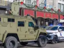 City police^ state police and Homeland Security officers^ and an armored vehicle and state patrol vehicle on Canal Street near the entrance to Bourbon Street New Orleans^ LA^ USA - January 2^ 2025