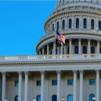 Close-up of the United States flag in front of the Capitol Building's dome in the morning^ Washington^ D.C.
