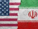 United States of America vs Iran - Cracked concrete wall painted with a USA flag on the left and a Iranian flag on the right