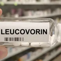 Bottle of LEUCOVORIN tablets on a hospital pharmacy table used to reduce methotrexate toxicity a folinic acid supplement.