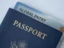 Global Entry card (Trusted traveller) covered of Passport of United states on white background.