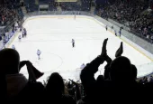 hockey fans applaud at ice hockey stadium