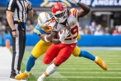 KC Chiefs running back Kareem Hunt #29 runs past LA Chargers linebacker Daiyan Henley #0 during an NFL football game at SoFi Stadium^ Aug. 17^ 2024^ in Inglewood^ Calif.
