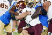 Arizona State running back Cam Skattebo #4 runs against UCLA defensive line Gary Smith III #58 and defensive back Alex Johnson #36 during an NCAA college football game^ Nov. 11^ 2023^ in Pasadena.