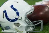 Indianapolis Colts helmet shown on field next to football; Colts host the Oakland Raiders on 9/29/19 at Lucas Oil Stadium in Indianapolis IN-USA