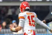 KC Chiefs quarterback Patrick Mahomes #15 runs to escape a tackle by LA Chargers outside linebacker Bud Dupree #48 during an NFL football game at SoFi Stadium^ Aug. 17^ 2024^ in Inglewood^ Calif.