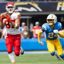 KC Chiefs tie end Travis Kelce #87 catches a pass next to LA Chargers safety AJ Finley #24 during an NFL football game at SoFi Stadium^ Aug. 17^ 2024^ in Inglewood^ Calif.