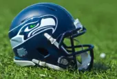 NFL Seattle Seahawks replica helmet on artificial grass playing turf ^ product shot