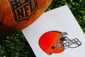Cleveland Browns NFL team Logo and American football ball on Green Grass. CLEVELAND^ USA^ FEBRUARY 10^ 2025