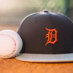 MLB Baseball ball with Detroit Tigers cap on pitchers mound.