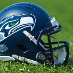 NFL Seattle Seahawks replica helmet on artificial grass playing turf ^ product shot