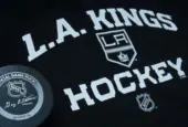 Official NHL game puck with LA kings equipment ^ product shot