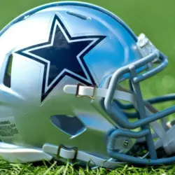 NFL Dallas Cowboys helmet on artificial grass playing turf ^ product shot