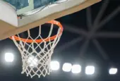 Basketball hoop hanging in a sports stadium waiting for the ball