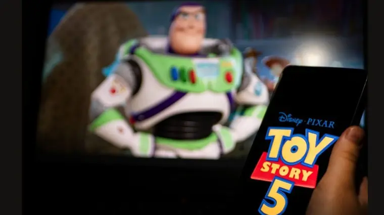 New Disney film Toy Story 5. A man's hand holds a phone with a poster of the new cartoon Toy Story 5 by Pixar. Moscow November 2025.