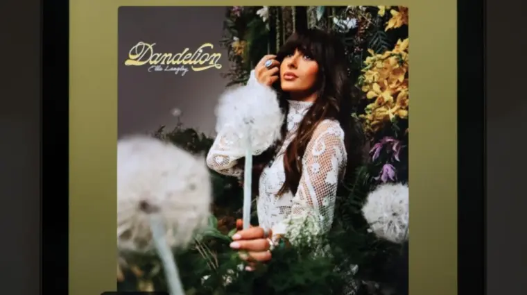 The image displays an Apple iPad running the Spotify app^ which shows the song "Be Her" by country artist Ella Langley from her album Dandelion.