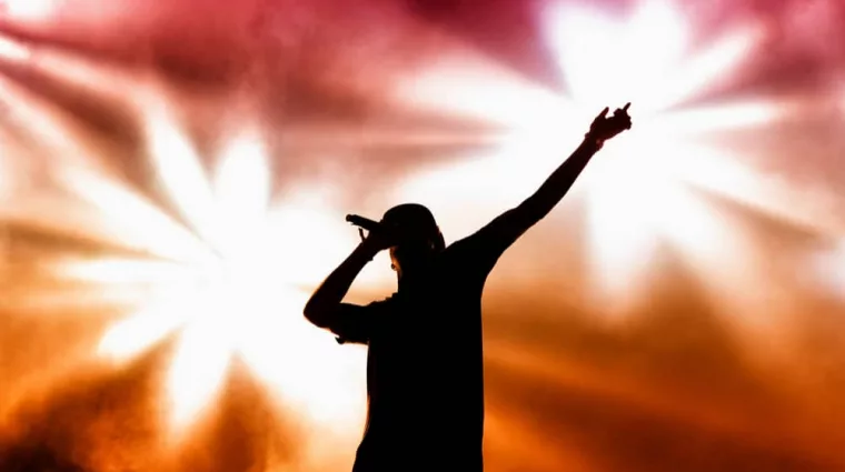 rapper on stage performing ;silhouette