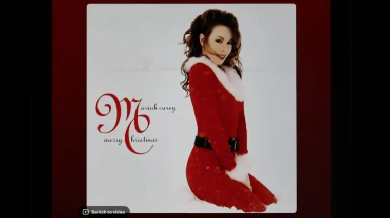 Mariah Carey's classic holiday album Merry Christmas from Spotify's interface on an Apple iPad. The currently selected track is "All I Want for Christmas Is You".