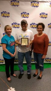Z100's Tracy McSherry-McKown with Bill Sizemore and Cheryl Ruzich with a plaque presented in honor of the $15,500 raised at last year's event!