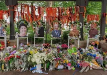 Highland Park^ IL July 16^ 2022^ memorial to the High Park parade shooting victims with their photos and flower bouquets^ mass shooting
