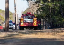 Fire company vehicles along Route 528 in Jackson^ NJ during a planned controlled burn of a section of the New Jersey pine barrens. Jackson^ NJ / USA - February 22 2020