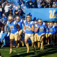 UCLA players run onto the field before an NCAA college football game between the UCLA and the Arizona State^ Nov. 11^ 2023^ in Pasadena^ Calif.