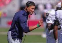 Notre Dame's Marcus Freeman congratulates his team after a score at Razorback Stadium^ Fayetteville^ AR. Sept 27^ 2025