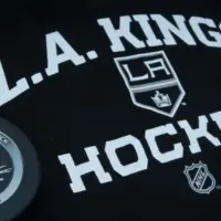 Official NHL game puck with LA kings equipment ^ product shot