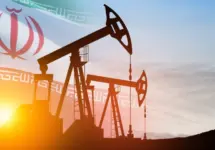 Oil drilling derricks at desert oilfield with Iran flag. The change in oil prices caused by the war. Oil prices are rising because of the global crisis. Crude oil production from the ground.
