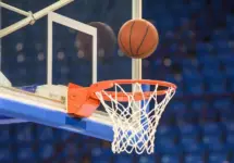A basketball flying into the basket