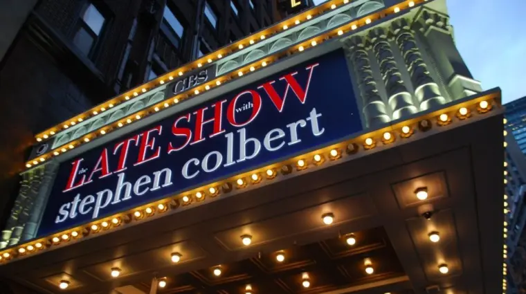 Manhattan NYC buildings in Times Square^ Broadway street avenue road^ signs for Stephen Colbert Late Show- Marquee / Theatre at Night
