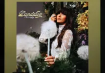 The image displays an Apple iPad running the Spotify app^ which shows the song "Be Her" by country artist Ella Langley from her album Dandelion.