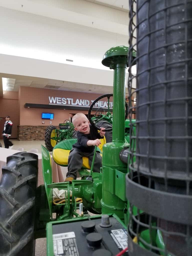 Hunter Powell, 2, enjoys a seat on an antique tractor.