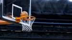 Large basketball arena; closeup of basketball going into hoop