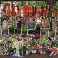Highland Park^ IL July 16^ 2022^ memorial to the High Park parade shooting victims with their photos and flower bouquets^ mass shooting