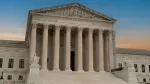 Greek classical architecture of the United States Supreme Court building with sunrise in background.