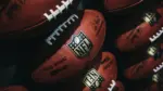 Rows of american football balls in NFL Experience in Times Square^ New York.