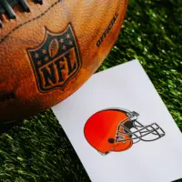 Cleveland Browns NFL team Logo and American football ball on Green Grass.