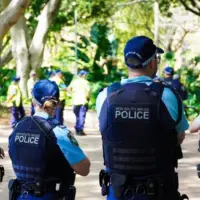 Crime in Sydney Australia. Close up of a NSW Police officers uniform sleeve patch and his communication device. Sydney^ NSW Australia - October 6 2024