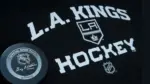 Official NHL game puck with LA kings equipment ^ product shot