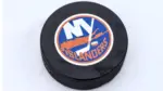 New York Islanders logo on Ice hockey puck outdoors in snow OREBRO^ SWEDEN - FEBRUARY 3^ 2019