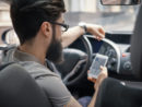 man-using-mobile-phone-while-driving_158595-4198