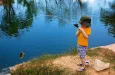a-cute-little-boy-reeling-in-a-big-fish