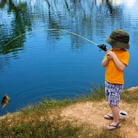 a-cute-little-boy-reeling-in-a-big-fish