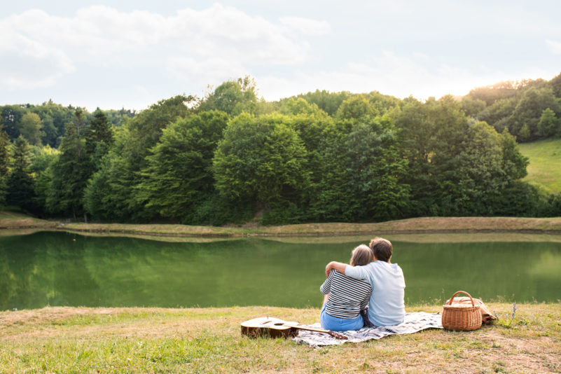 senior-couple-at-the-lake-having-a-picnic