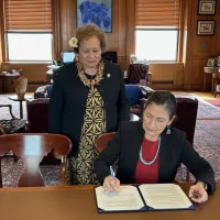 congresswoman-amata-looking-on-as-secretary-haaland-signs-the-document-making-american-samoas-amendments-official