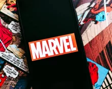 Marvel comics logo on the background of comic pages
