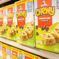 A view of several boxes of Chewy chocolate chip granola bars^ on display at a local grocery store.